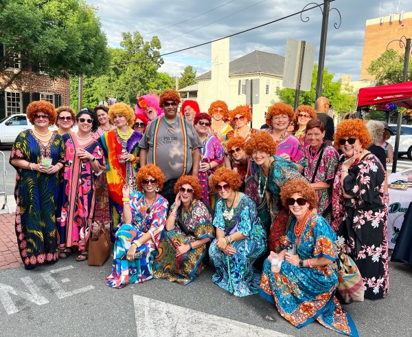 Group photo of diverse people dressed up for a Mrs. Roper Romp hosted by FAHASS and the Downtown Dolls in Fredericksburg, VA.