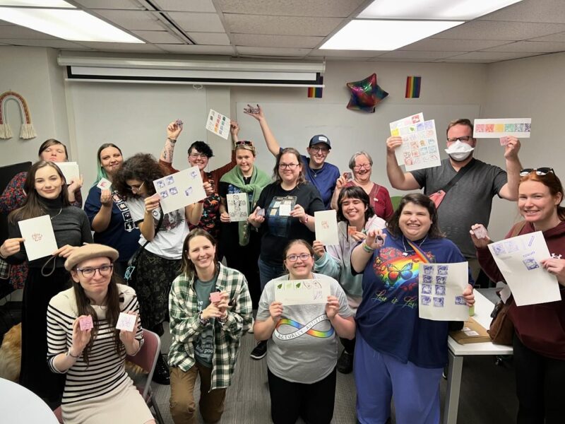 A group of friends showing off their linocut projects created at Queer Craft Night hosted by Pride Center FXBG and the House FXBG in Fredericksburg, VA.