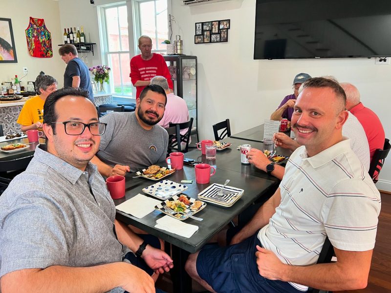 Cheerful group of diverse friends enjoying a monthly brunch at Rehana's, hosted by FAHASS' Pride Center in Fredericksburg, VA.